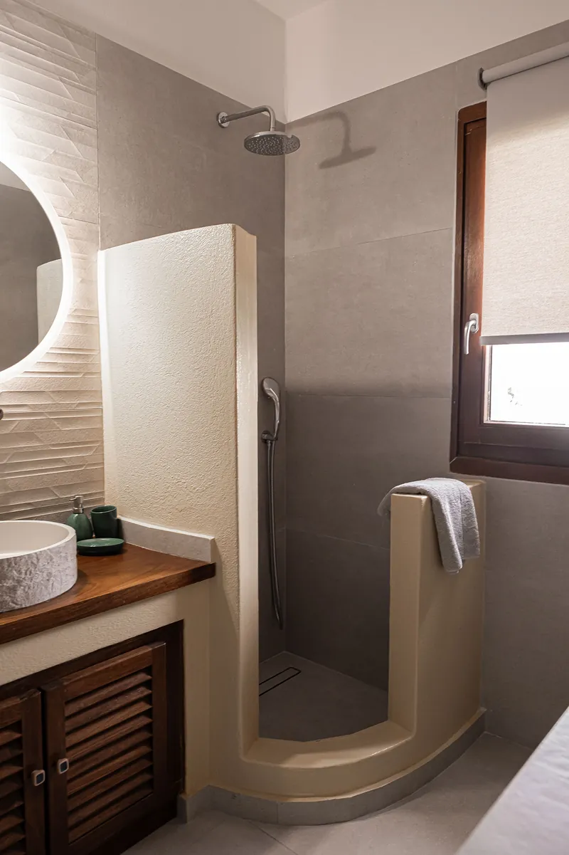 A bathroom with a walk-in shower