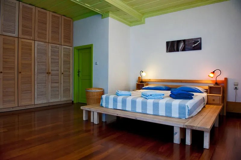 A bedroom with a timber wardrobe