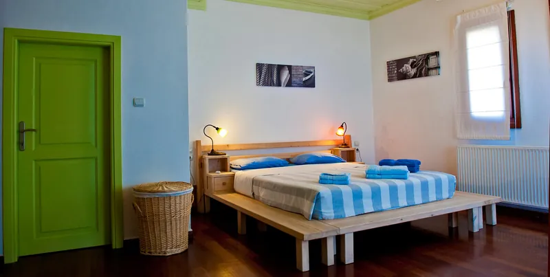 The bed and the green door of a bedroom
