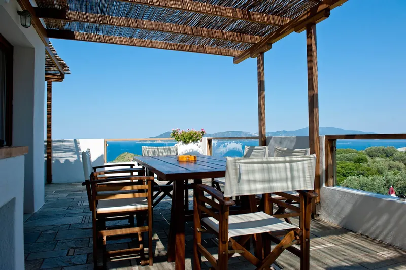 The dining table on the covered terrace, with the sea beyond