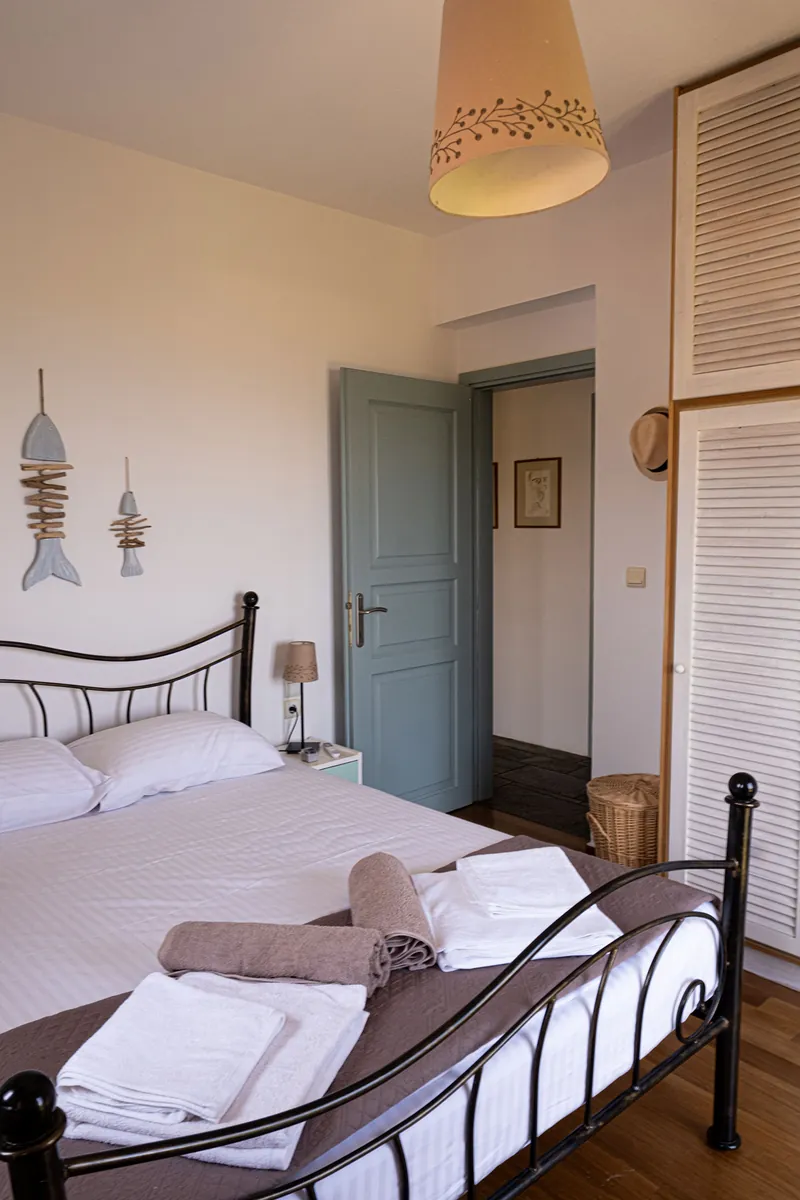 A bedroom with an iron bed