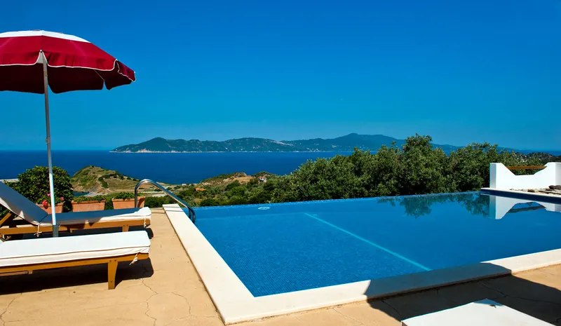 Loungers and a red umbrella beside the pool